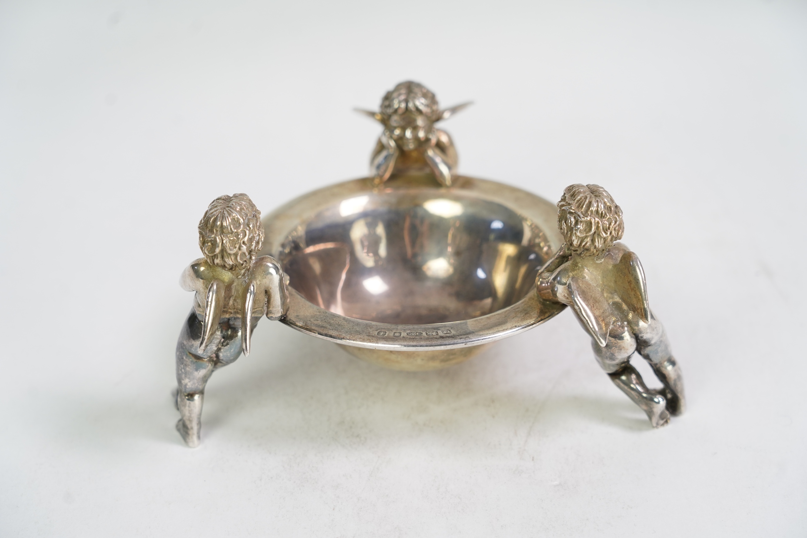 An Elizabeth II Theo Fennell silver bonbon bowl, with three cherub supports